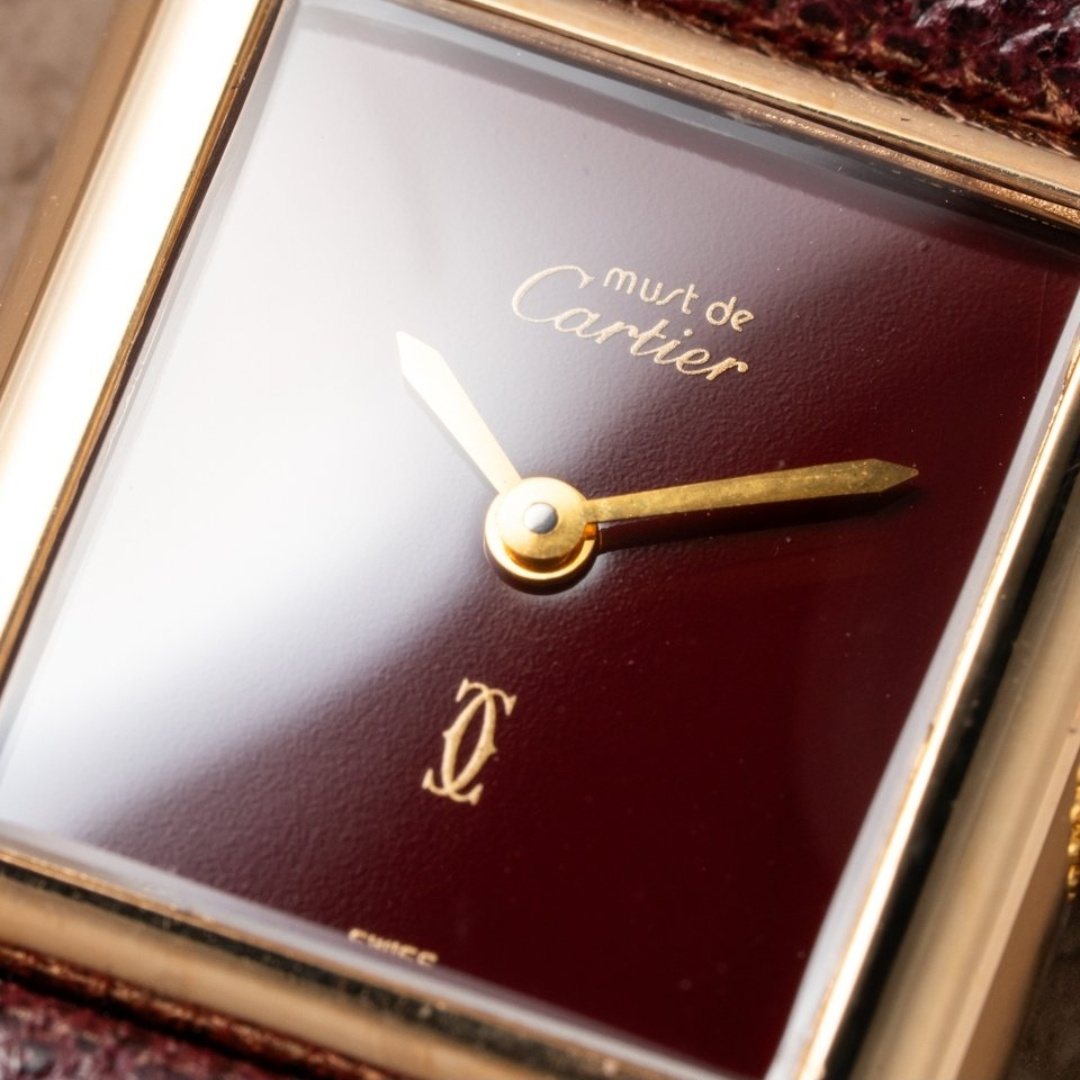 Close view of the dial — must de Cartier at the top, the interlocking double-C below the hands.