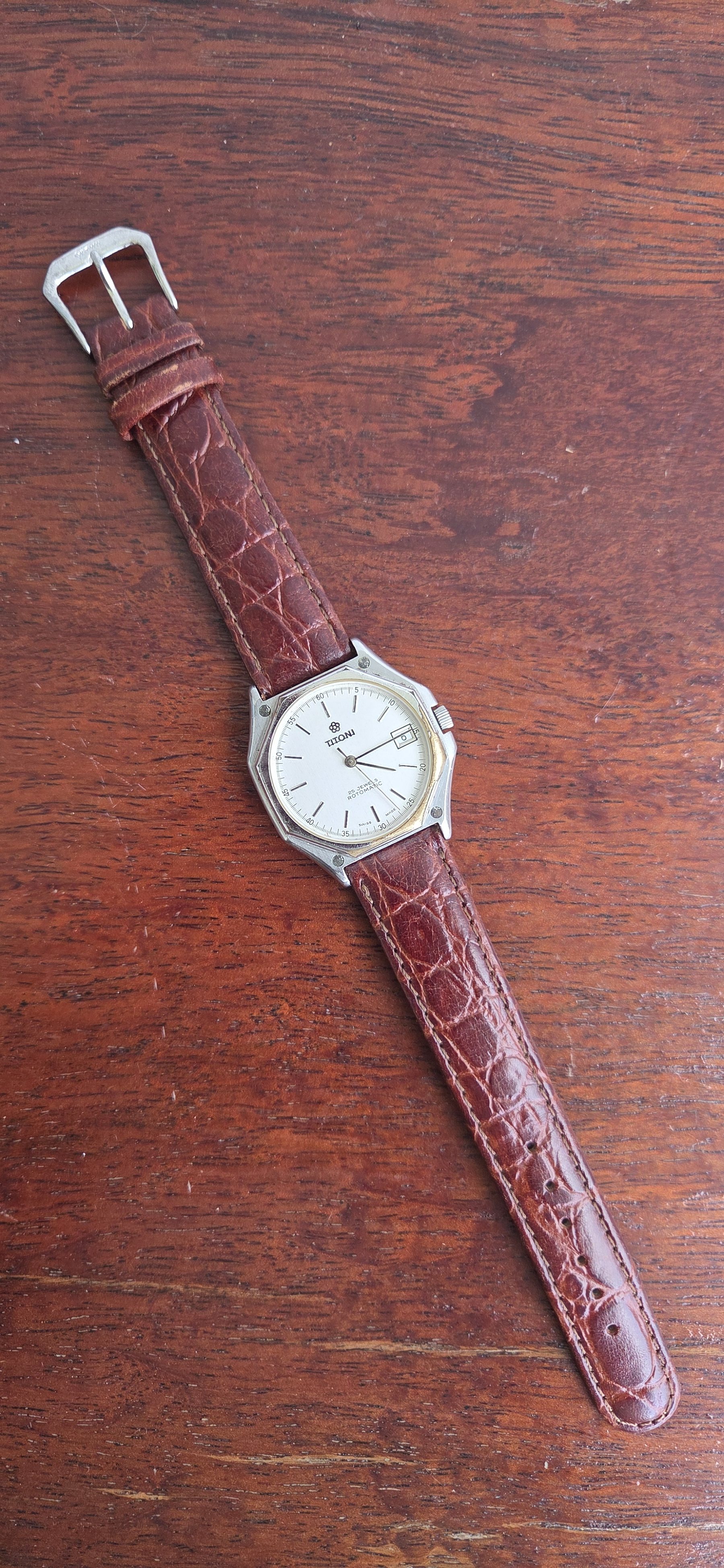 The whole watch laid out flat with the alligator strap extended.